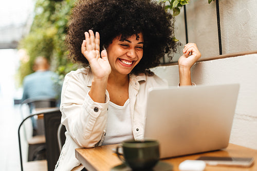 Female freelancer having a video call on her laptop in a coworking space