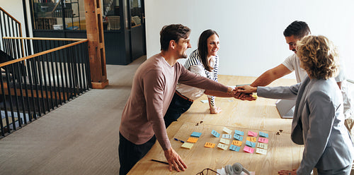 Business team stacking hands together in a meeting. Team spirit, motivation before starting a project