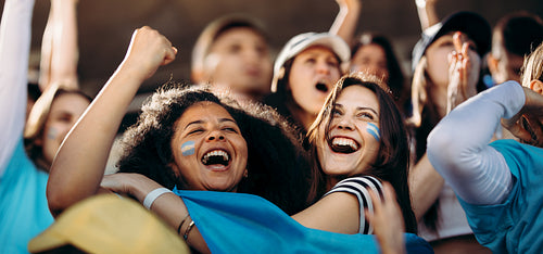 Excited crowd of sports fans celebrating their team's victory
