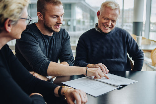 Business team discussing on contract terms in meeting