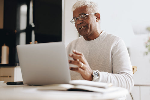 Mature business man having an online meeting at home