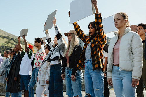 Diverse group of activists holding blank signs at an outdoor rally