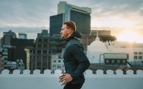 Man doing workout on rooftop