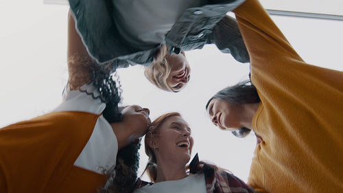 Friends jumping in a huddle