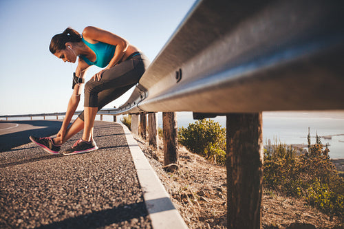 Sports woman stretching after running outdoors