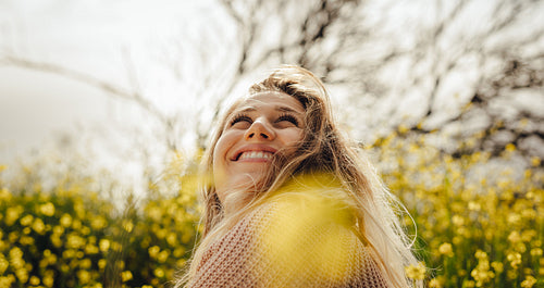Smiling young woman sitting in meadow