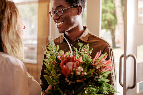 Man gives flowers to the beloved girl on date