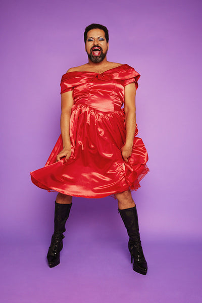 Man dressed in womans clothing performing in studio