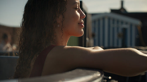 Relaxation surrounds the woman in a warm outdoor hot tub at a spa retreat