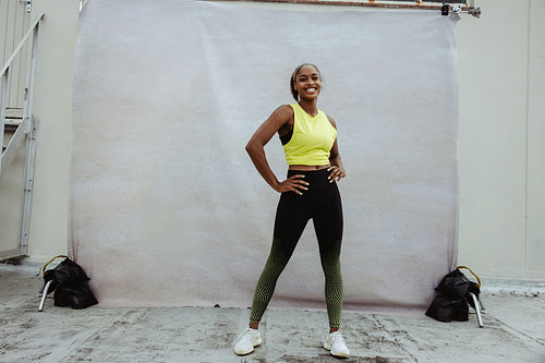 Confident fitness woman on building terrace