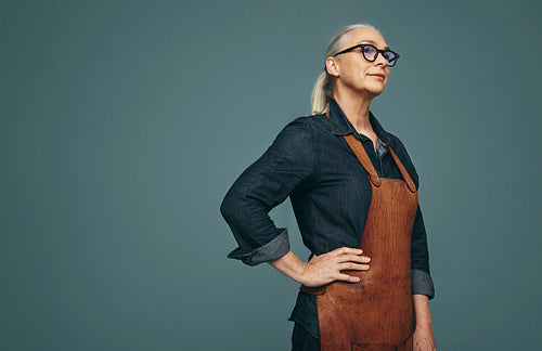 Thoughtful jewellery maker standing in a studio