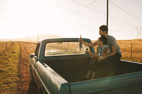 Couple enjoying on a road trip in their pick up truck
