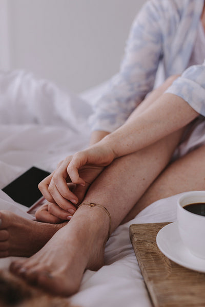 Woman sitting in bed with breakfast