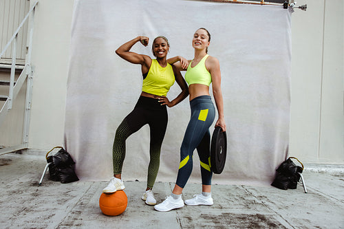 Two sports women with muscular body on rooftop