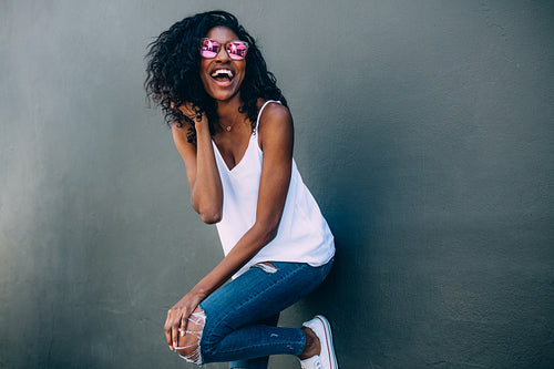 Portrait of a woman standing against a wall