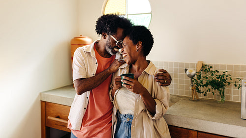 Happy mature couple enjoying quality time together in a cozy kitchen