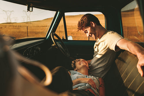 Couple enjoying on a road trip in their pick up truck