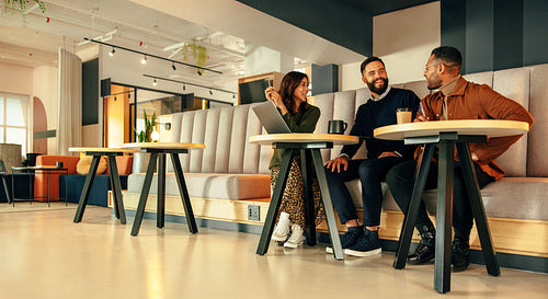 Three businesspeople working together in an office lobby