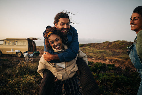 Friends playing and having fun during a camping trip