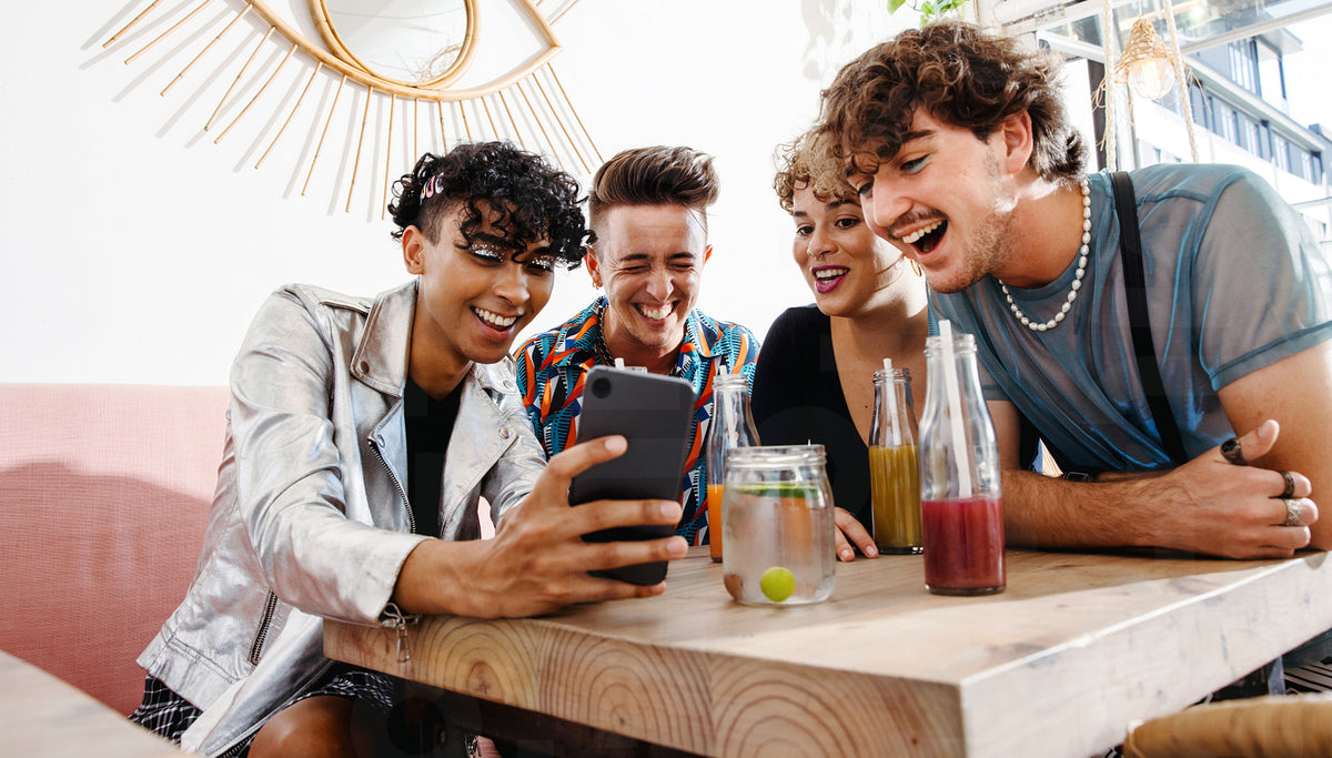 Young people video calling their friends in a restaurant – Jacob Lund ...