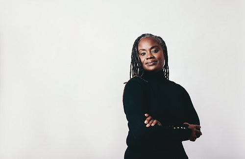 Mature woman with dreadlocks looking at the camera in a studio