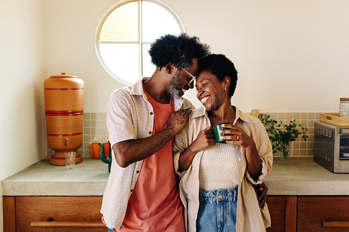 Mature couple looking in love in their home kitchen