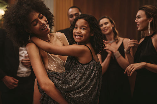 Mother enjoying dancing with her daughter at party