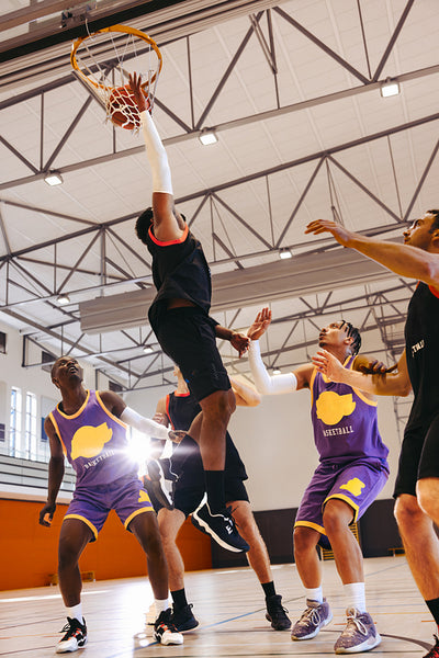 Basketball players competing on a court