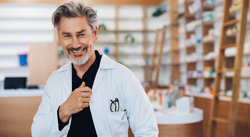 Senior doctor standing in a pharmacy