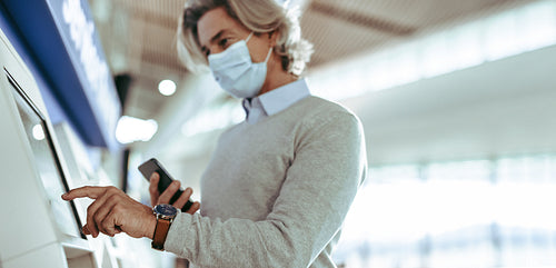 Air traveler doing self check in at airport
