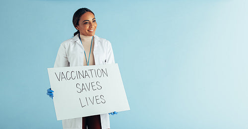 Doctor showing vaccination awareness signboard
