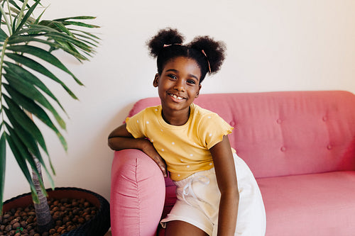 Happy young girl relaxing on a sofa at home