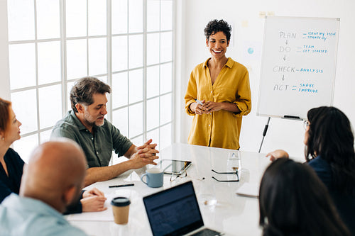 Professional black woman having a discussion with her colleagues in an office