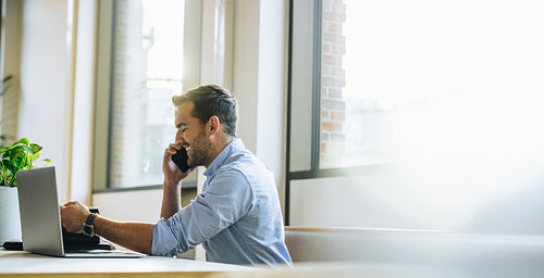 Businessman talking with client on smart phone