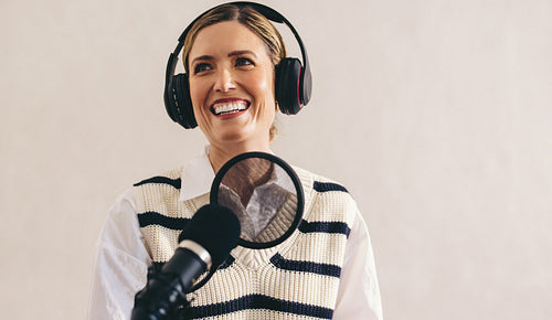 Happy woman hosting a radio show