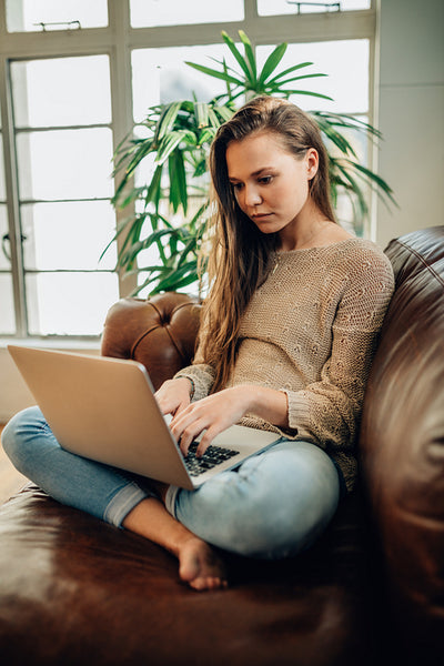Woman working on a laptop computer at home