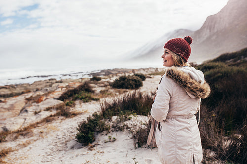 Beautiful young woman at beach on winter day