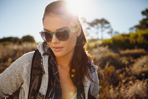 Woman hiking in a sunlit nature reserve