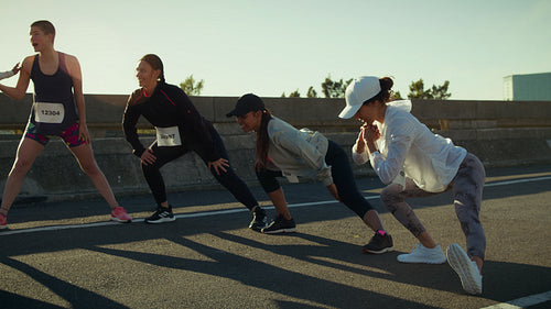 Runners stretching before a marathon race