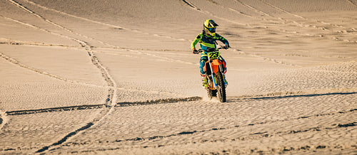 Motocross rider riding in the desert sand