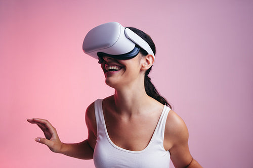 Happy young woman entering a fun virtual reality game