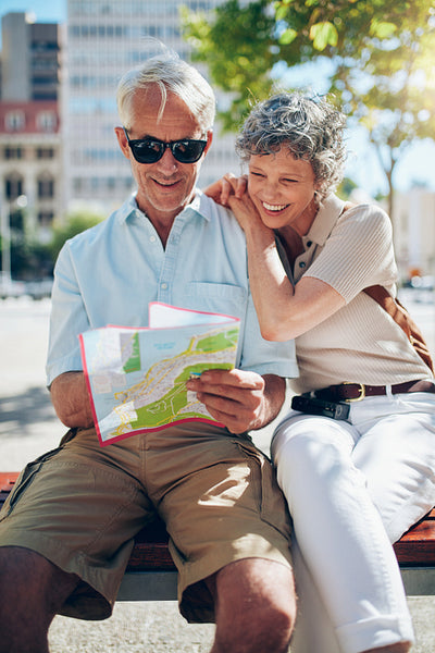Mature tourist reading city map