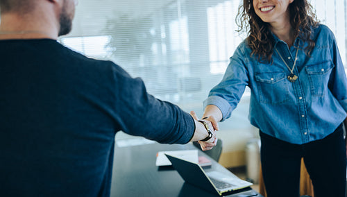 Two businesspeople handshake after meeting