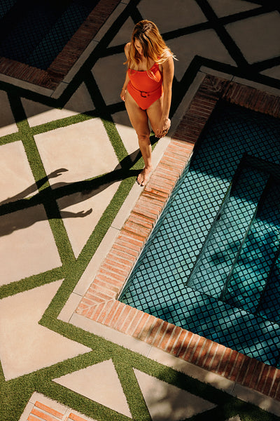 Top view of a tourist woman going for a swim in red swimwear