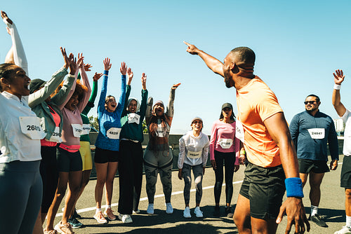 Group of runners cheering and celebrating at a community event