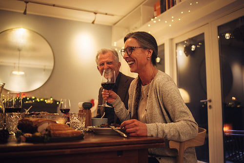 Senior couple enjoying having christmas dinner with family