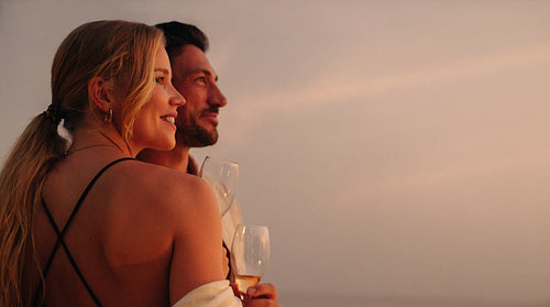Romantic couple enjoying sunset, celebrating love and togetherness