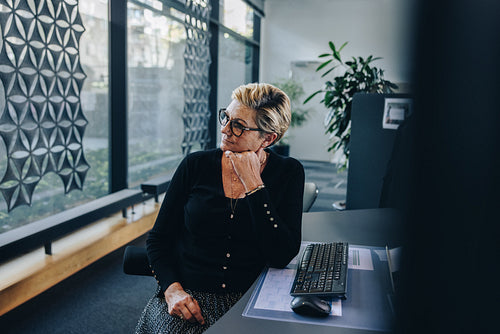 Stressed businesswoman relaxing at her desk