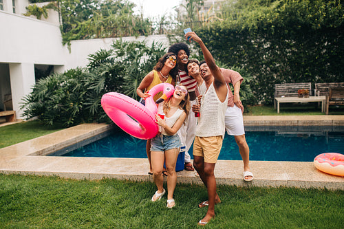 Friends take a selfie by the pool