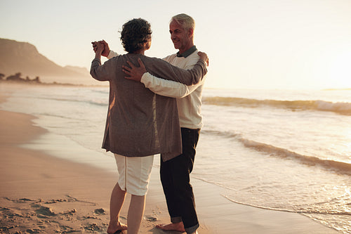 Senior couple dancing on the beach